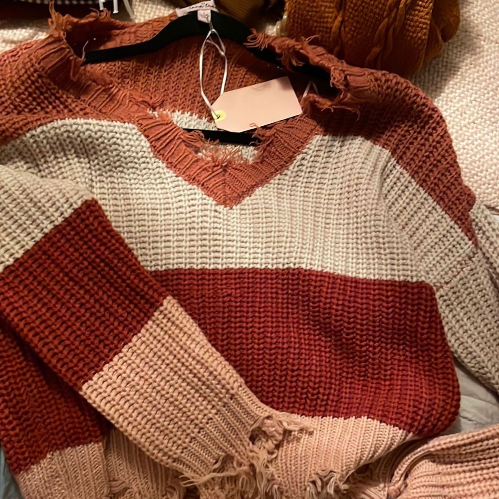 Very cute, size large but is cropped and would fit a S or XS